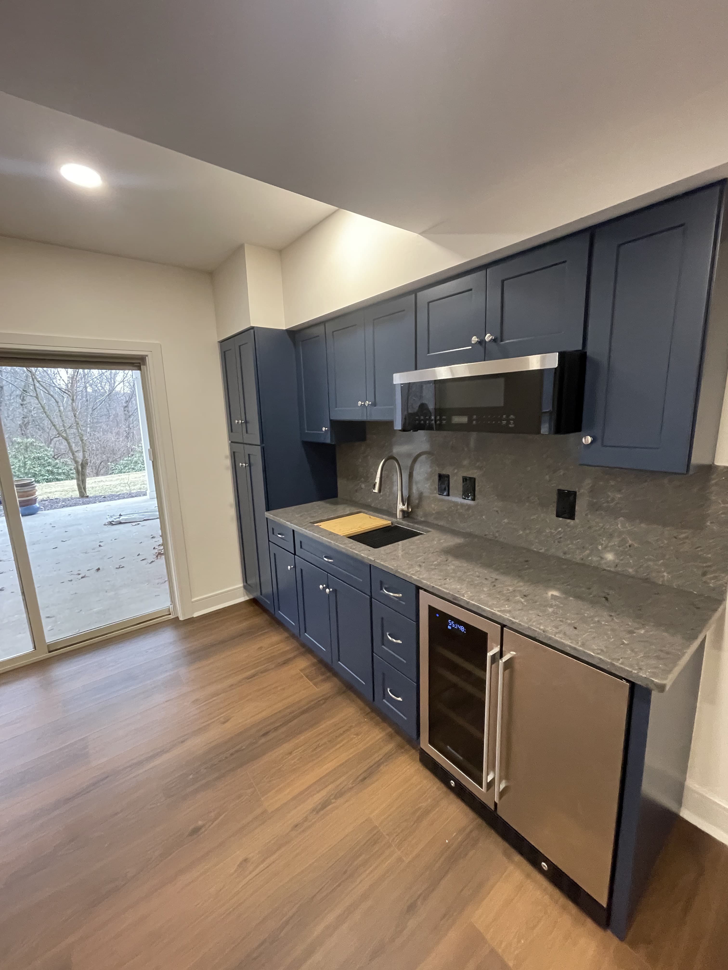 Finished kitchen remodel with blue cabinets and new countertops.